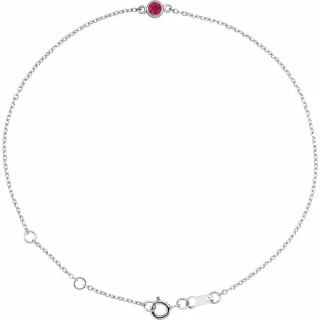 Silver bracelet with a red gemstone on a white background